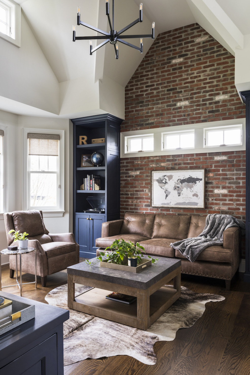 brick-wall-living-room-leather-couches-faux-fur-rug