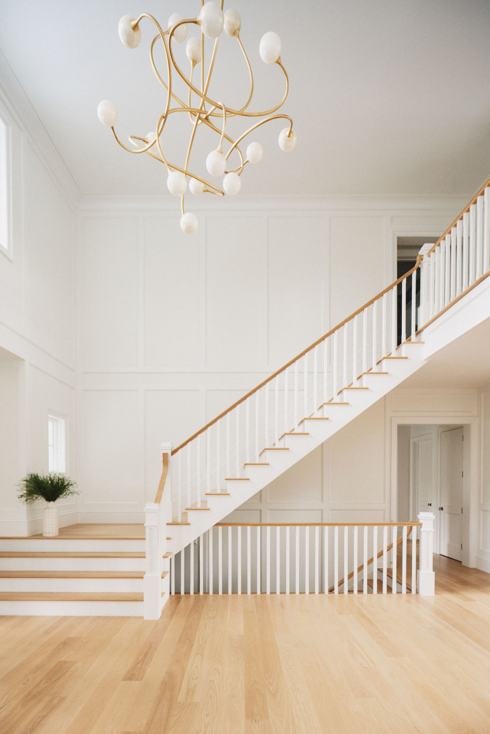 large-foyer-ith-unique-chandelier-and-staircase